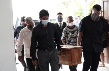 Pallbears carry the body of Samuel Colin Ming into the church for viewing. Among them are his brother Stanley (Second on left), his nephew Calvin and (third on left) and his son Samuel (Third on right) (Elvin Croker Photo)