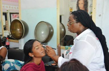 Pamela Dillon in her salon applying makeup to a past Talented Teen Queen