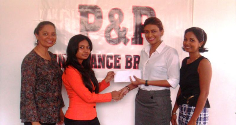Pranita Seedath (2nd left), P&P Accounting Officer presents the cheque to GLTA secretary Elizabeth Persaud (2nd right) while P&P’s Ahilya Panday (left) and GLTA treasurer Ileana Boodhoo (right) look on.