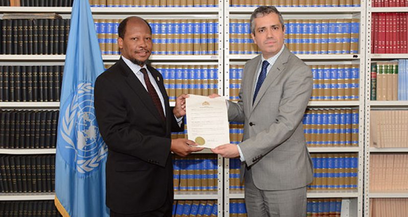 Ambassador George Talbot, left, presents the instrument of ratification of the Paris Climate Agreement to Mr. Santiago Villalpando, Chief of the Treaty Section of the Office of Legal Affairs of the UN