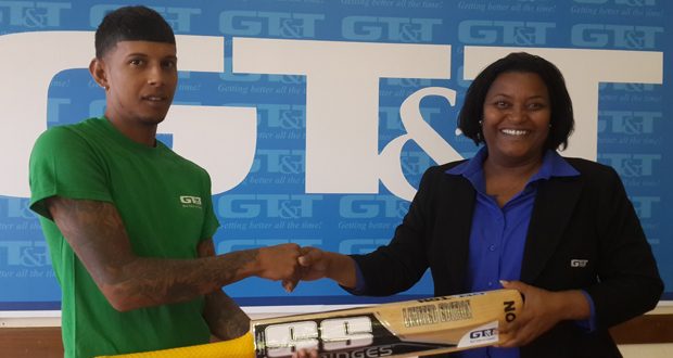 Here you go Chris! Public Relations Officer of GT&T Alison Parker (right) smiles broadly as she makes the presentation of the SS branded bat to Christopher Patandin.