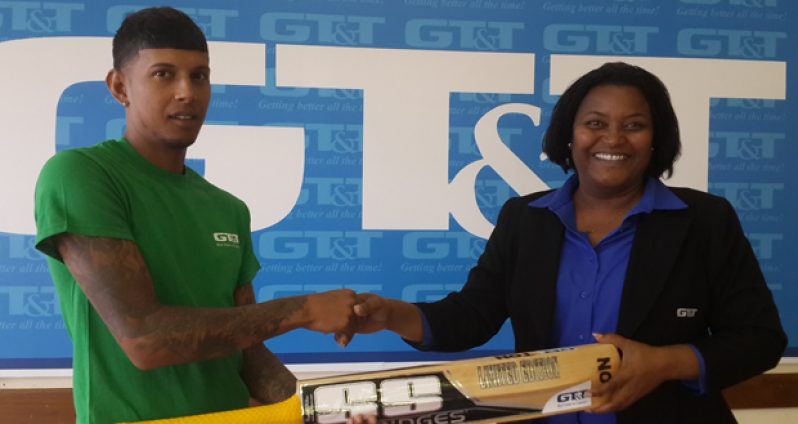 Here you go Chris! Public Relations Officer of GT&T Alison Parker (right) smiles broadly as she makes the presentation of the SS branded bat to Christopher Patandin.