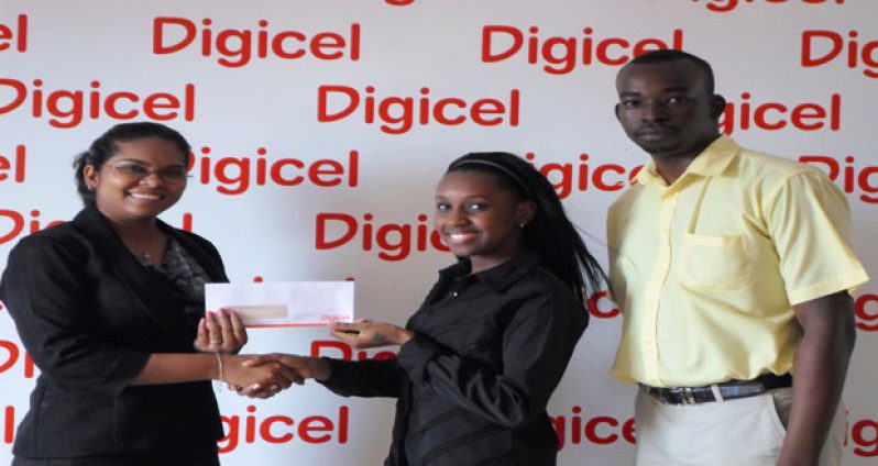 Digicel’s Communications Manager, Vidya Sanichara presents cheque to Javanka Williams, while Mr. Cary Gillis looks on.