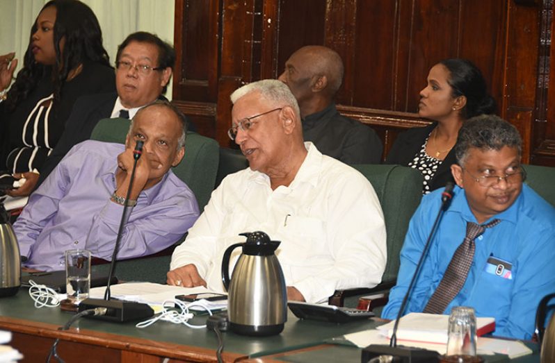 Minister of Agriculture, Noel Holder has a word with GuySuCo executive, Paul Bhim as the Committee of Supply of the National Assembly debated the sums allocated to the sugar workers