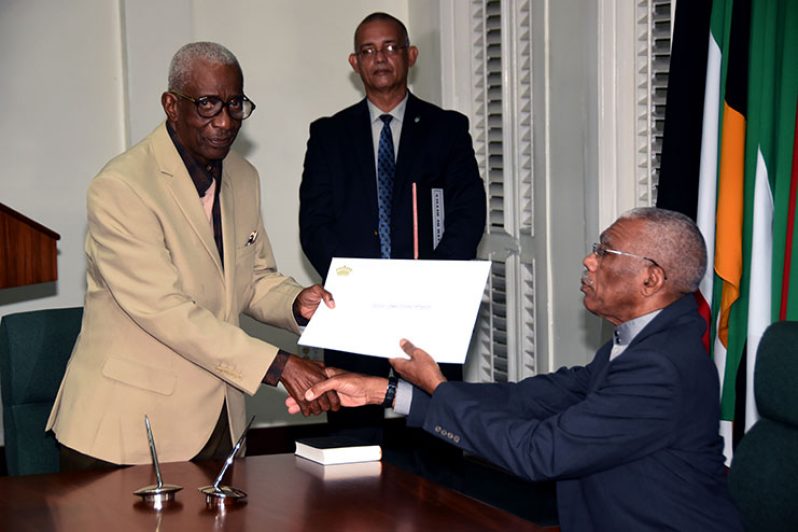 President David Granger presenting Justice James Patterson with his letter of appointment after he was sworn in as Chairman of the Guyana Elections Commission (GECOM) back in October, 2017