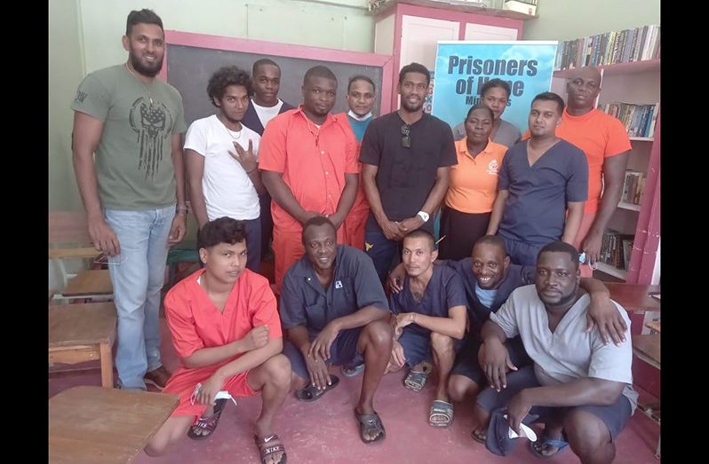 West Indies cricketer, Keemo Paul (black shirt) along with friend Siddiq Mohamed (far left) and inmates of the Timerhi Prison after a recent visit