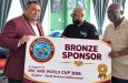 Photo shows Raj Singh congratulating Satyendra Khemraj aka Samba, owner of the New Doctors clinic in the presence of Paul Archer, World Cup transportation coordinator