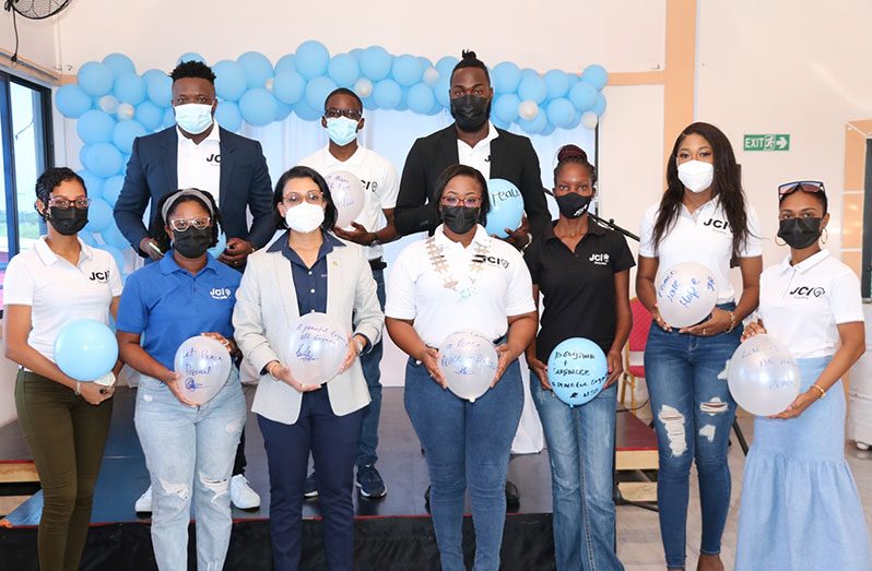 Minister within the Ministry of Housing and Water, Susan Rodrigues (third from left), and members of the Junior Chambers International-Guyana signed peace balloons