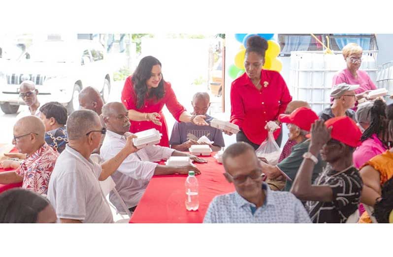 Minister of Human Services and Social Security, Dr Vindhya Persaud, engages pensioner