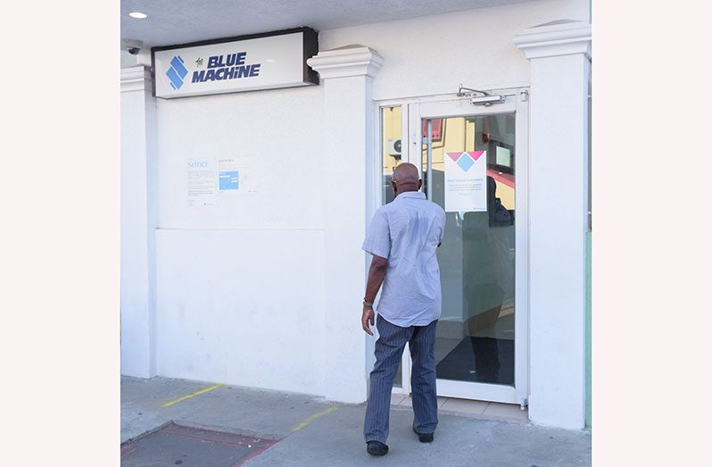 A pensioner enters a local ATM (Delano Williams photo)