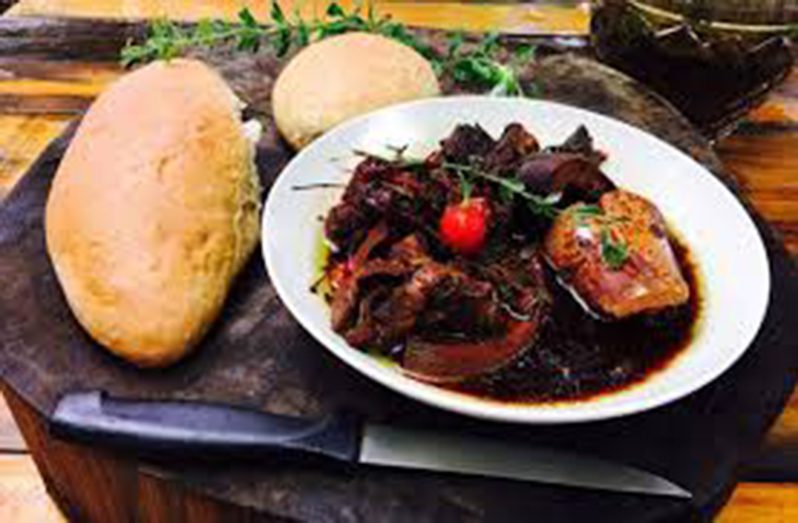 Traditional Guyanese Pepperpot tabled with home-made bread