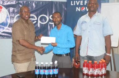 GBA president Steve Ninvalle receives the sponsor’s cheque from Pepsi brand manager Larry Wills while GBA technical adviser looks on (Sonell Nelson photo)
