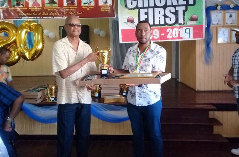 Former national coach Albert Smith (left) presents   trophy to Andre Percival