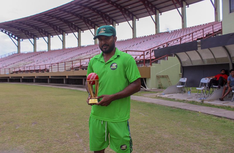 Veerasammy Permaul poses with his trophy presented by the GCB for taking 500 1st class wickets