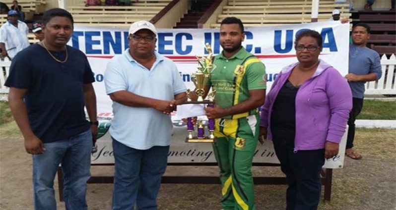 Captain Shawn Perreira receives the winning trophy and cash incentives from Imtiaz Bacchus in the presence of BCB officials Angela Haniff and Vicky Bharosay.