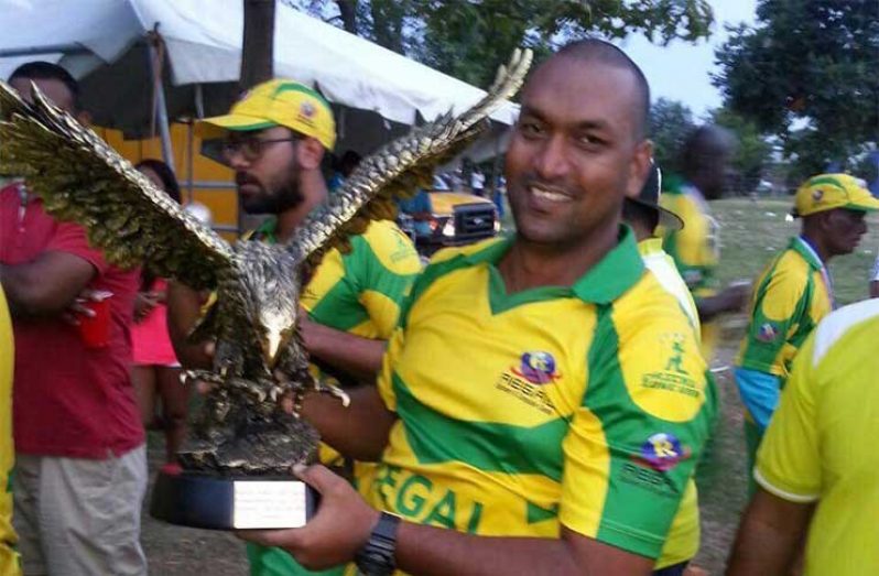Flashback! Manager of the Regal Allstars, Parmanand Persaud, lifts the winning 2016 trophy.