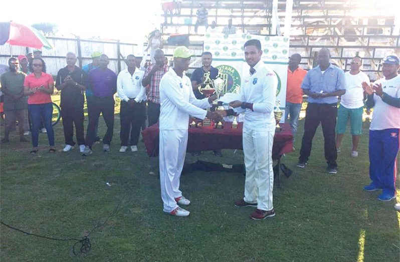 Shivnarine Chanderpaul presents Akshaya Persaud with the Best Batsman award.