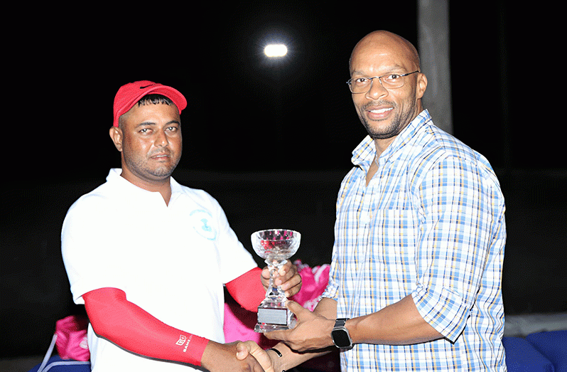 Avinash Persaud collects his championship trophy from Chief Operations Officer (COO) of Business Solutions, Orson Ferguson