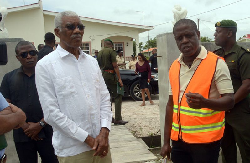 President David Granger (left) is briefed by CH&PA CEO, Lelon Saul, about some of the developments slated for the Perseverance Housing Scheme