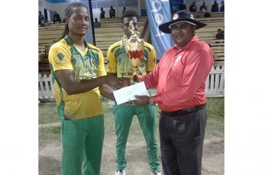 BCB-appointed executive, Neil Rudder, hands over trophy to Clinton Pestano and Kevin Sinclair.