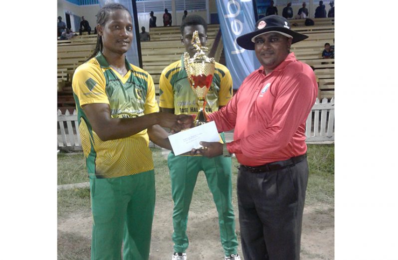 BCB-appointed executive, Neil Rudder, hands over trophy to Clinton Pestano and Kevin Sinclair.