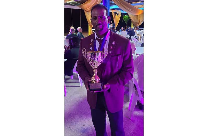 Rifle shooting ace Peter Persaud poses with his winning trophy