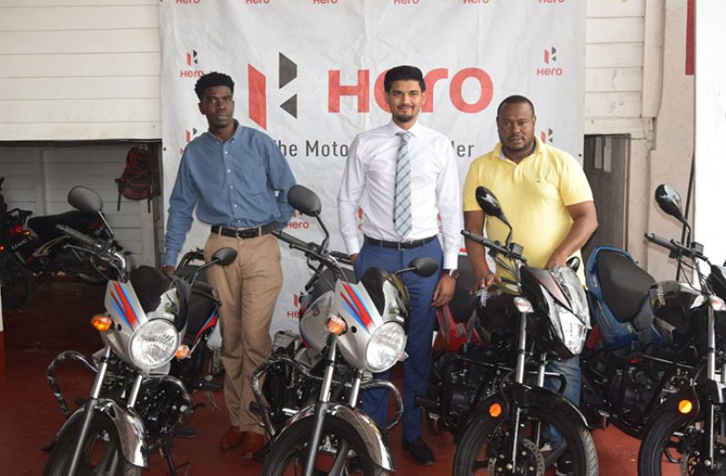 From left, Petra's Mark Alleyne, Joshua Ramdehol and Troy Mendonca pose with some of the Hero Honda motorcycles yesterday.