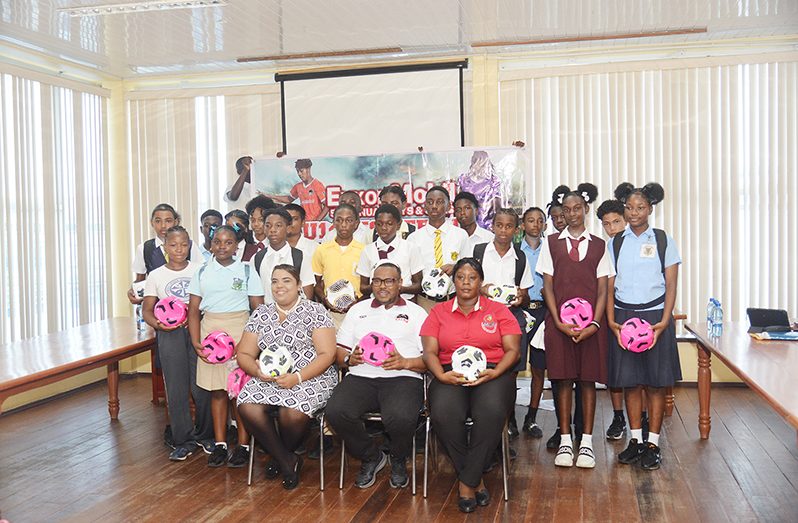 Petra Co-Director Troy Mendonca (Centre, sitting) is flanked by officials and players of the upcoming ExxonMobil U-14 Schools' Football championships (Japheth Savory photo)