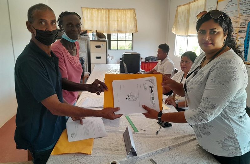 An APNU representative submitting the party’s list of candidates in Annandale Riverstown NDC