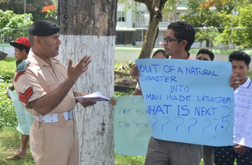 Chenapao village Toshoa, Edward Mc Garrell engaging a police officer during Wednesday morning’s protest outside the Ministry of the Presidency (Ravin Singh photos)