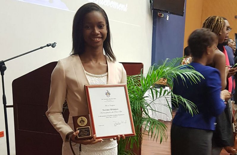 Larissa Wiltshire with the two awards she copped at UWI, Mona, recently