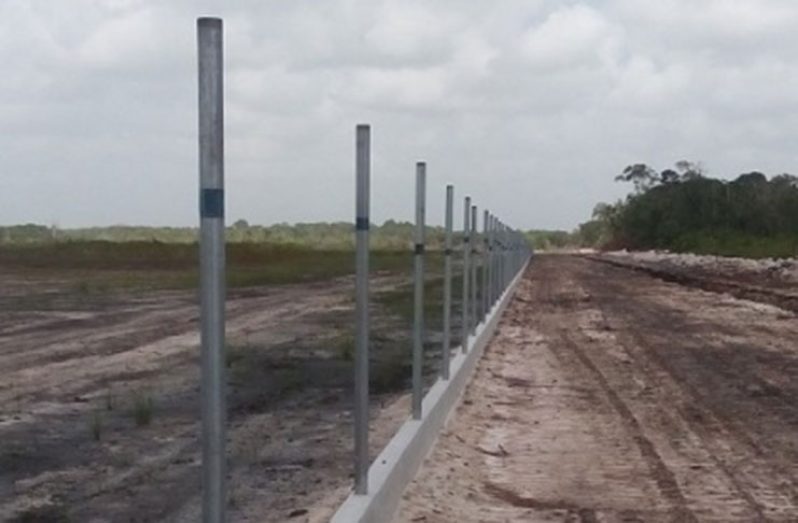 The eastern fence of the dumpsite being prepared