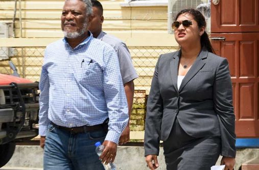 Former Prime Minisster, Samuel Hinds, leaving the Special Organised Crime Unit (SOCU) on Wednesday in the company of his lawyer, Priya Manickchand