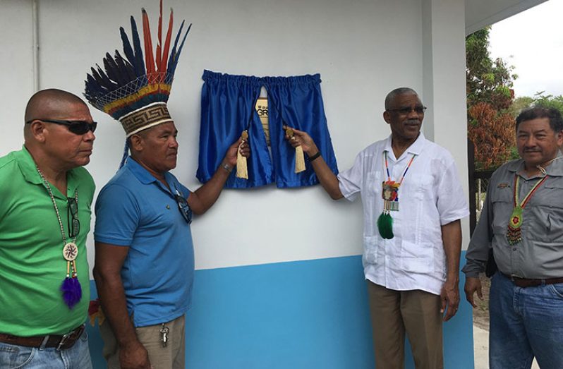 President David Granger is assisted by Toshao of Orealla David Henry, to unveil the plaque to officially commission Radio Orealla 95.1, while Minister of Social Cohesion, Dr. George Norton and Minister of Indigenous Peoples' Affairs Sydney Allicock, look on
