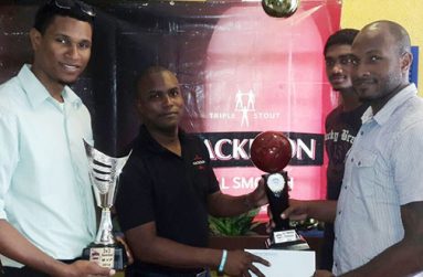 Pitbulls captain Ryan Gullen (right) receives the $500 000  cheque from Ansa McAl Mackeson brand representative Jamal Douglas while teammates Jermaine Slater and Akeem Kanhai look on.
