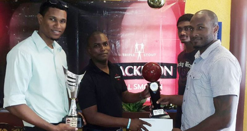 Pitbulls captain Ryan Gullen (right) receives the $500 000  cheque from Ansa McAl Mackeson brand representative Jamal Douglas while teammates Jermaine Slater and Akeem Kanhai look on.