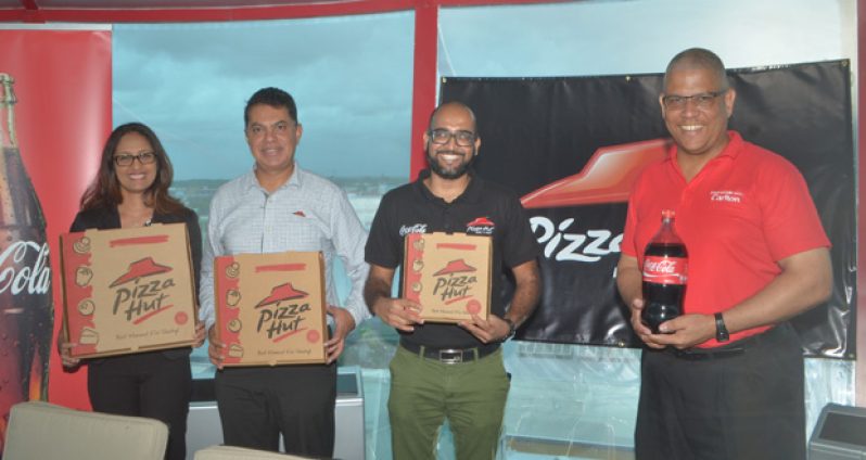 From left are Corum Group’s Padma Kunj Beharry, Latin America’s Franchise Coach Carlos Martines, Pizza Hut’s Director of Marketing Navin Singh and Banks DIH Marketing Executive Carlton Joao.