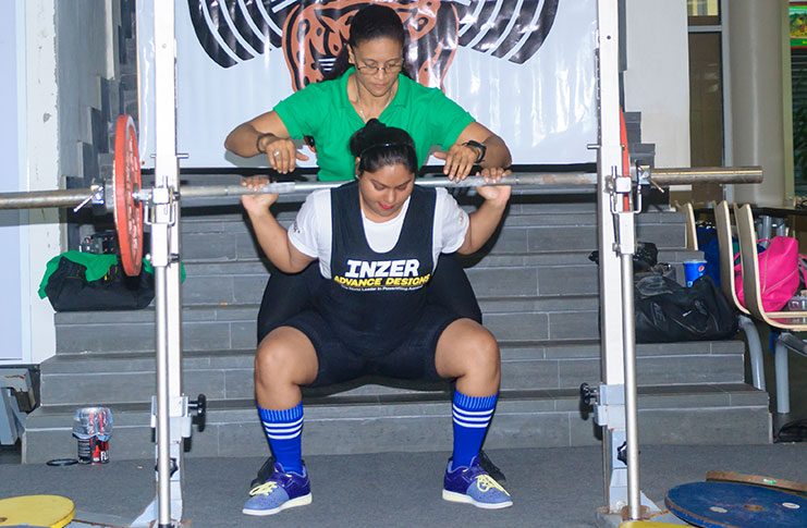 National record holder Lisa Oudit does a squat.