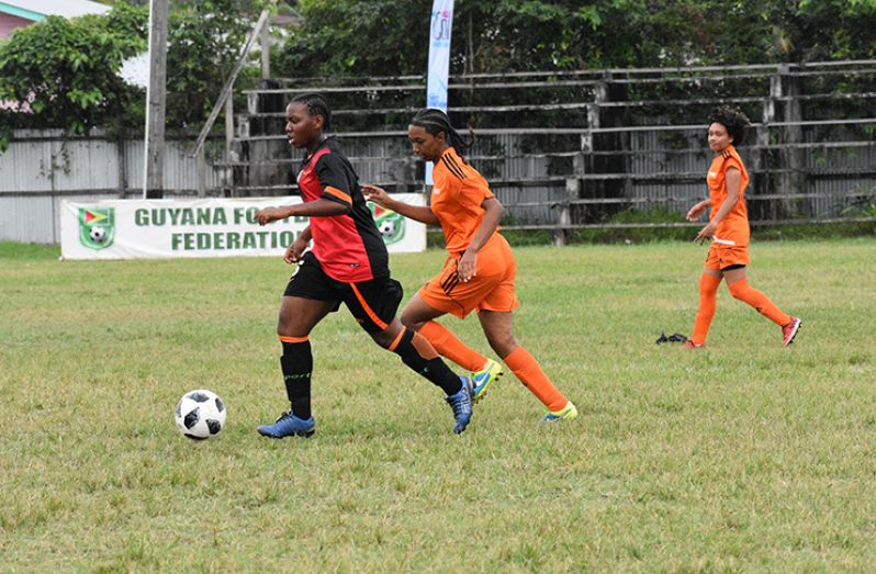 Fruta B Team player heads to goal, hotly pursued by the defender of Fruta Conquerors A team.