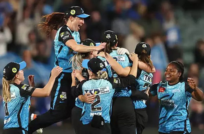 Adelaide Strikers players celebrate their victory.