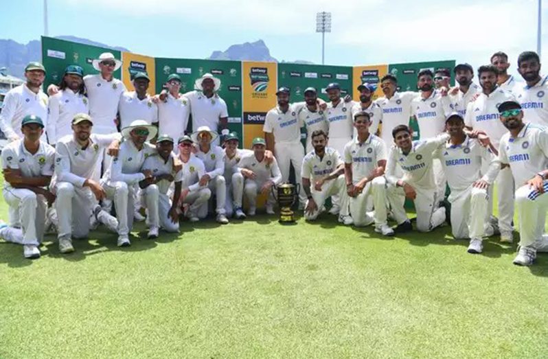 India and South Africa players pose with the winning trophy after the series ended 1-1.