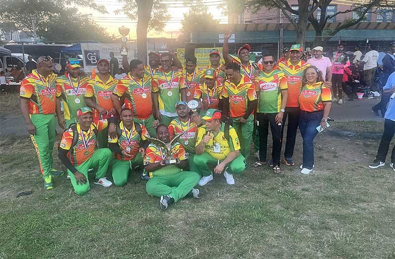 The victorious Regal Masters players and supporters pose with their winnings.