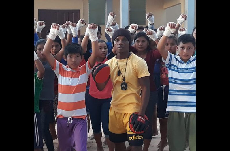Hinterland boxing coach Orlan 'Pocket Rocket' Rogers with boxers from Region 8