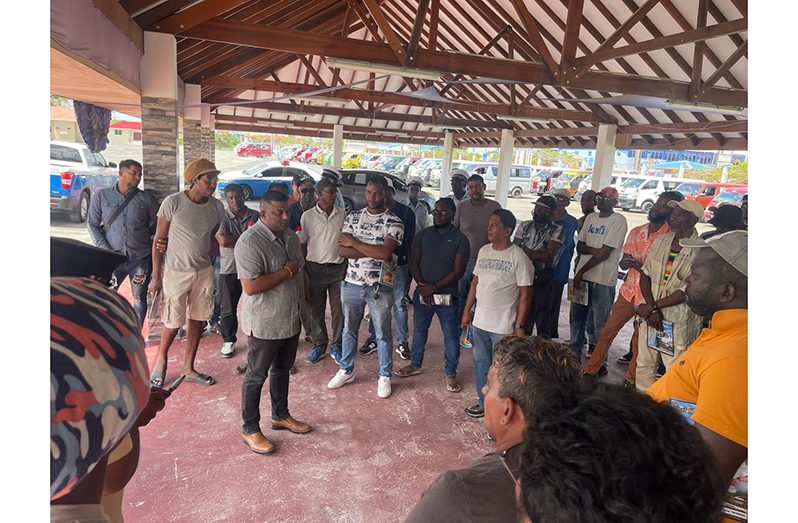 Traffic Chief Mahendra Singh and other senior officers from the GPF speaking with some of the Route 42 minibus operators at the Guyana National Stadium last weekend