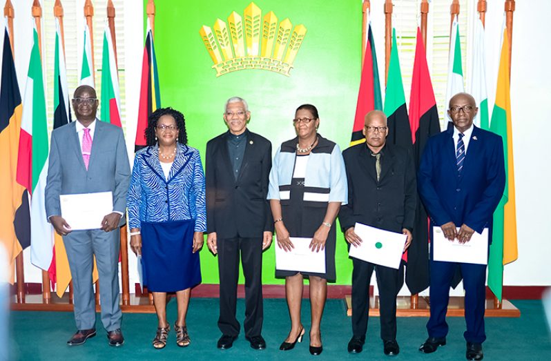 President Granger flanked by members of the Police Service Commission (Delano Williams Photo)