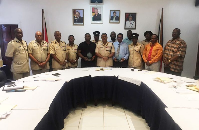 Acting Commissioner of Police David Ramnarine, at centre, is flanked by the two Superintendents who received the Prime Minister’s Medal and who were awarded a plaque each by the Force. Also present are senior officers of the Force's Performance Group.
