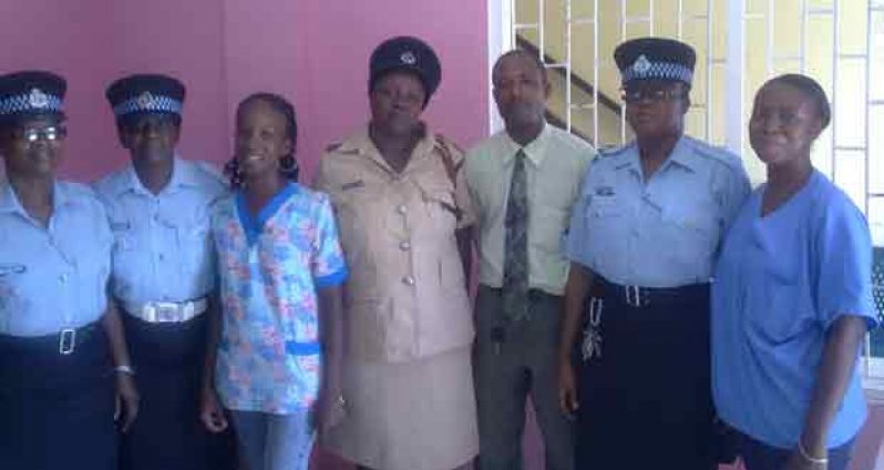 Inspector Griffith-Jacobis, Head of the Number Three Subdivision (centre) is flanked by the Sergeants; Administrator of the Drop-in Centre, Joel Gibson (right of Inspector Jacobis); and Caretakers at the Drop-in Centre after the luncheon