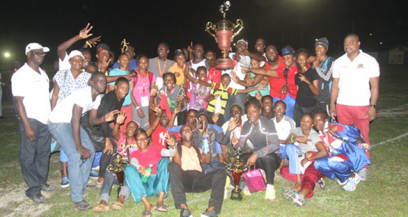 CHAMPS!!! Athletes from the Police Sports Club celebrate after winning the 2014 Boyce and Jefford Track & Field Classic last Sunday at the Mackenzie Sports Club. (Sonell Nelson photo)