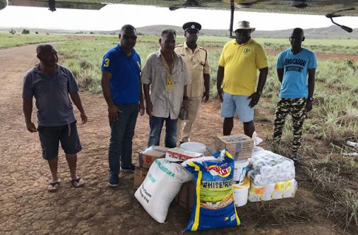 Commander Budhram (second from left) with CDC representatives and police ranks with some of the supplies donated