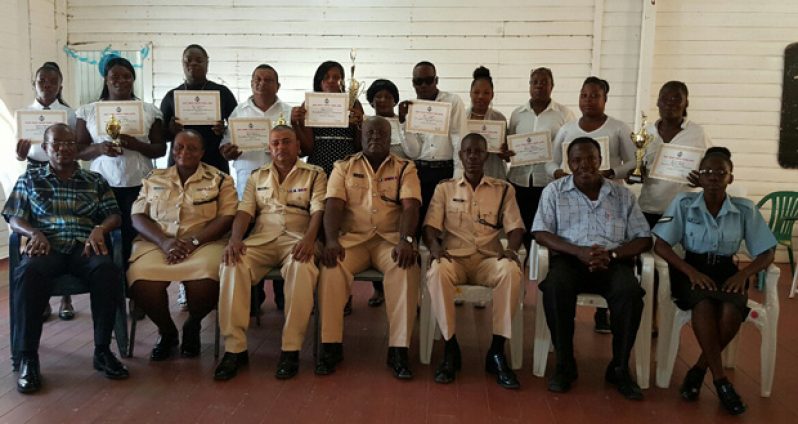 Commander of ‘D’ Divison Stephen Mansell with senior officers seated in front row flanked by participants of the two computer training courses, with their certificates and trophies on Monday after the graduation ceremony